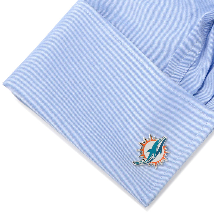 NFL Miami Dolphins Cufflinks attached to a light blue dress shirt cuff.