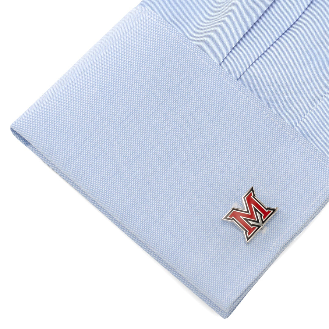 A light blue shirt cuff featuring NCAA Miami University of Ohio Cufflinks with a red and white letter M logo.