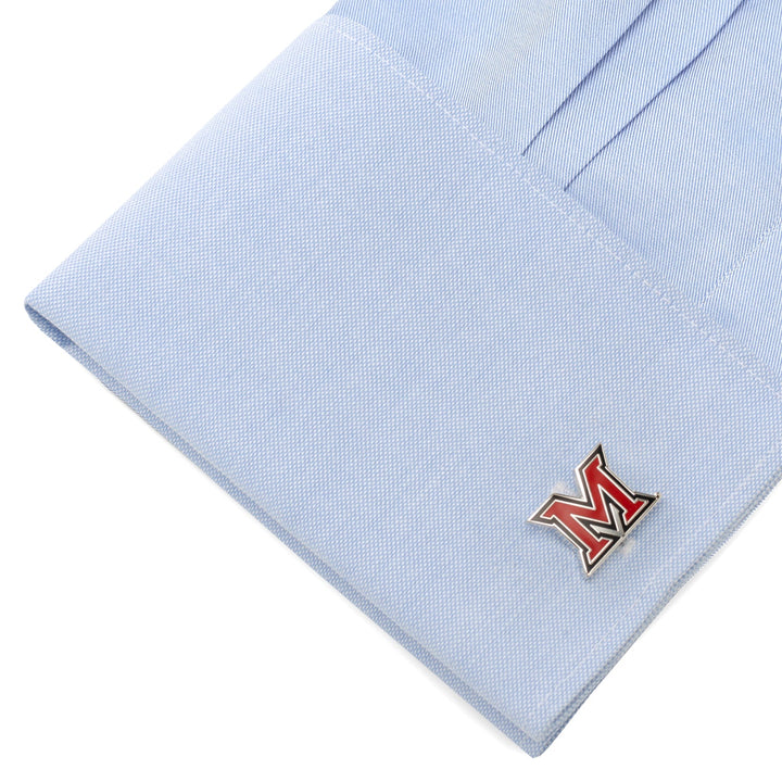 A light blue shirt cuff featuring NCAA Miami University of Ohio Cufflinks with a red and white letter M logo.