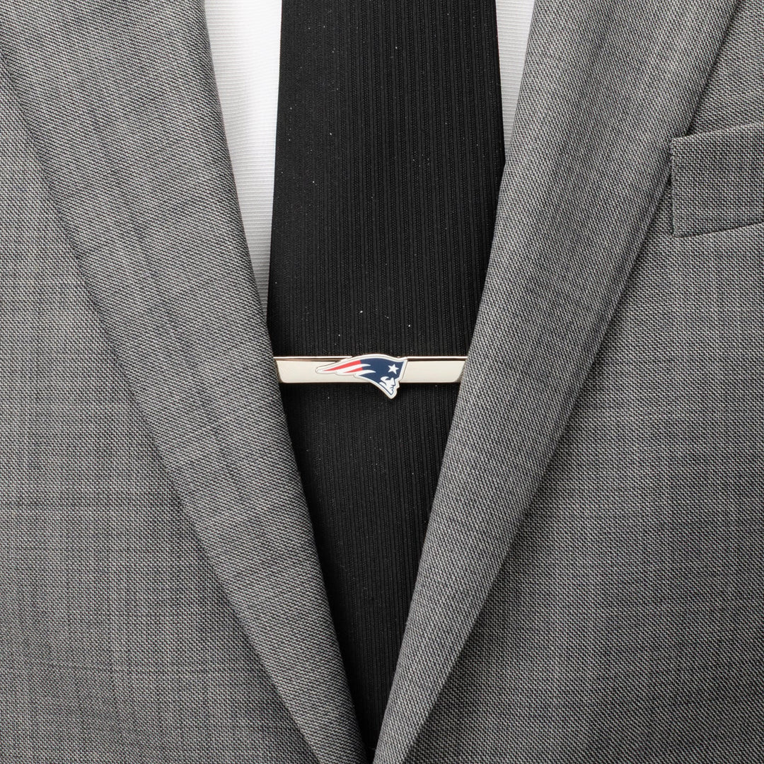 Silver-tone New England Patriots Tie Clip on a black necktie and grey suit jacket.