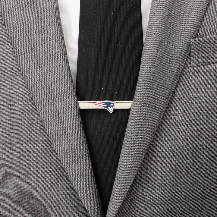 Silver-tone New England Patriots Tie Clip on a black necktie and grey suit jacket.