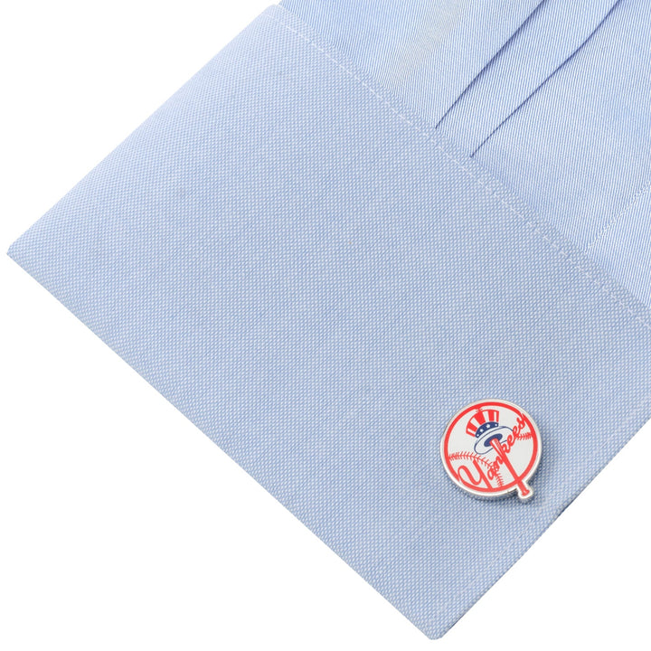 Round MLB New York Yankees Baseball Cufflinks on a light blue dress shirt cuff.