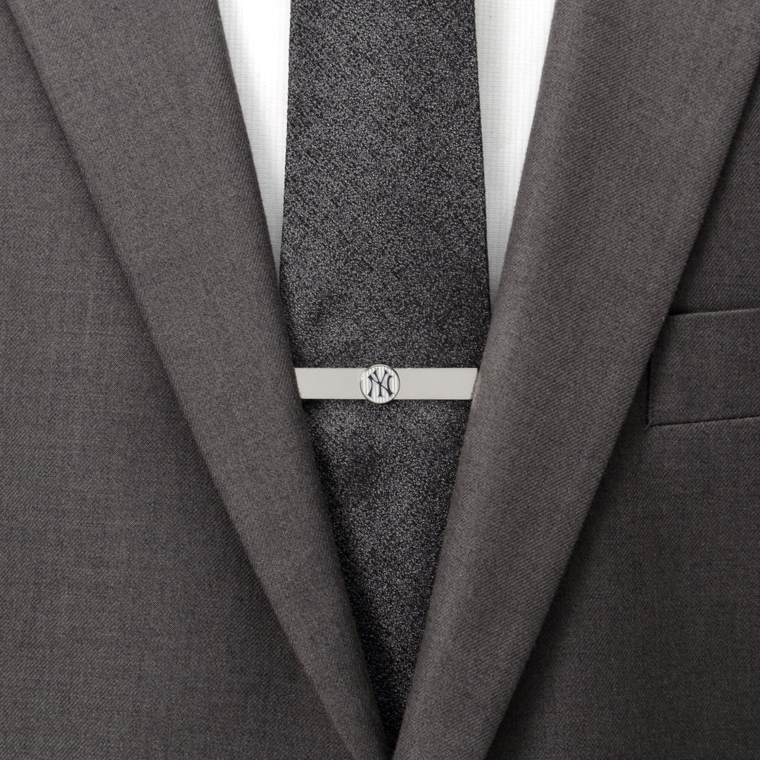 Silver MLB New York Yankees Pinstripe Tie Bar on a dark textured tie worn with a grey suit jacket.
