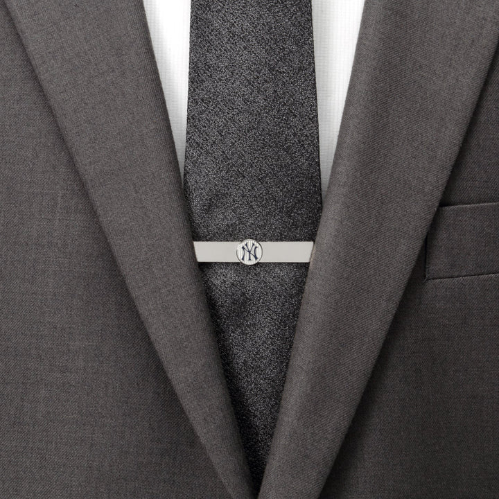 Silver MLB New York Yankees Pinstripe Tie Bar on a dark textured tie worn with a grey suit jacket.