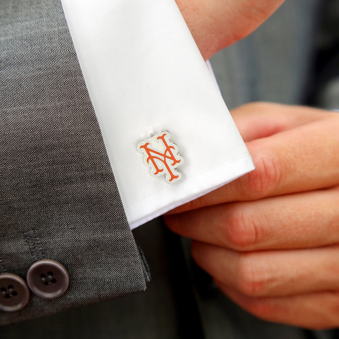 A person adjusts a white shirt cuff featuring MLB New York Mets Silver Cufflinks.