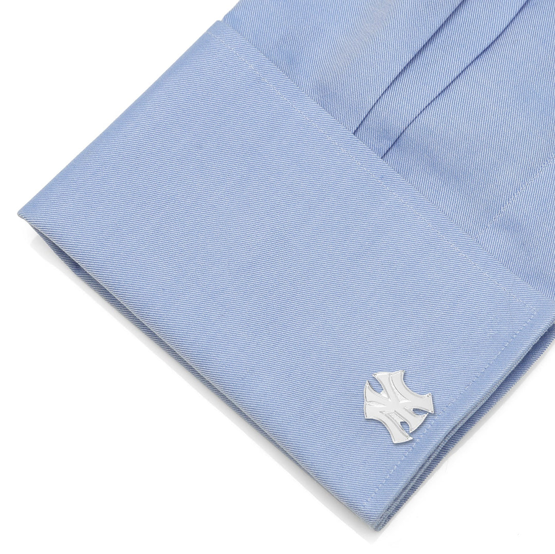 MLB New York Yankees Silver Logo Cufflinks attached to a light blue dress shirt cuff.