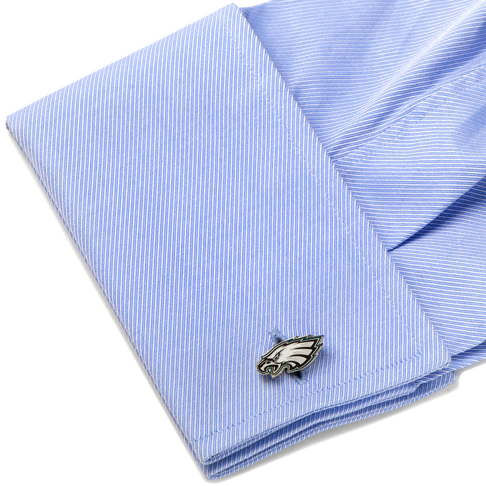 Silver-toned metal NFL Philadelphia Eagles Cufflinks attached to a light blue dress shirt cuff.