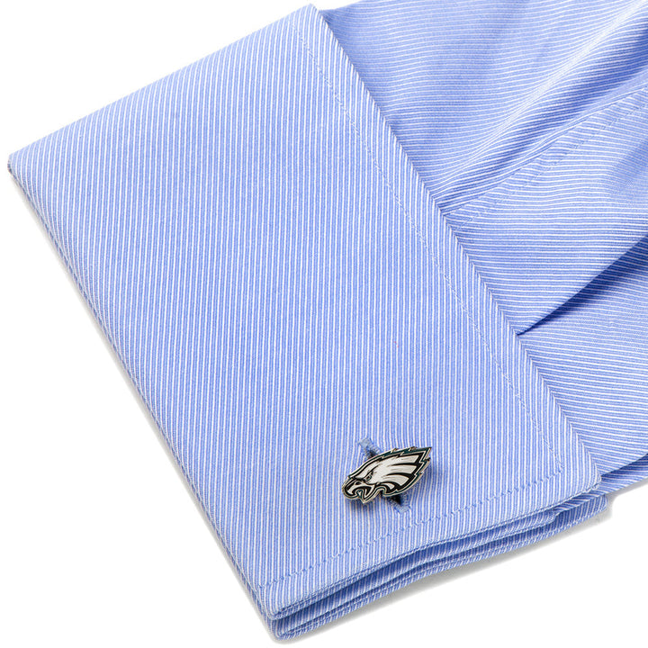 Silver-toned metal NFL Philadelphia Eagles Cufflinks attached to a light blue dress shirt cuff.