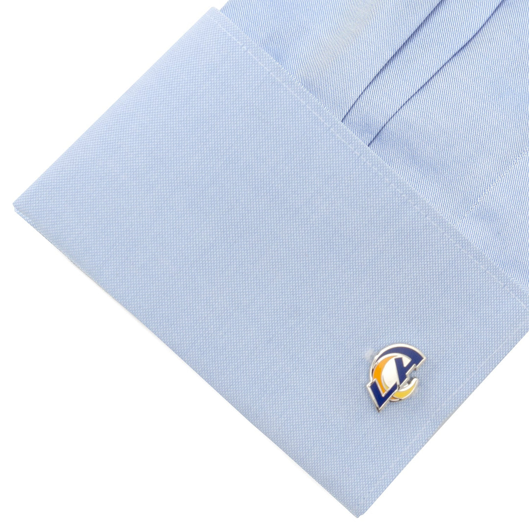 A light blue dress shirt cuff fastened with NFL Los Angeles Rams Cufflinks.