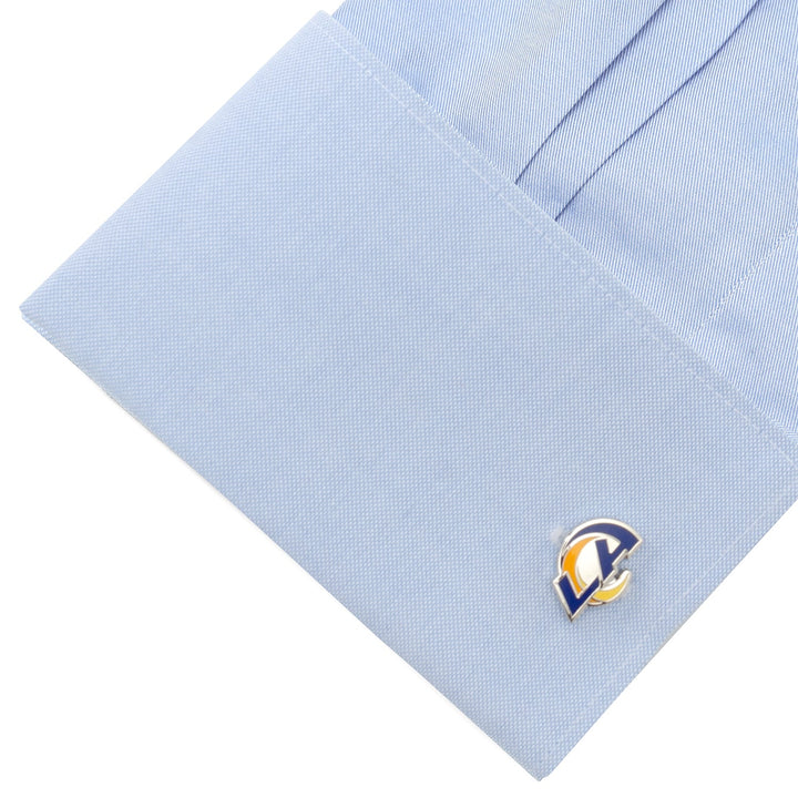 A light blue dress shirt cuff fastened with NFL Los Angeles Rams Cufflinks.