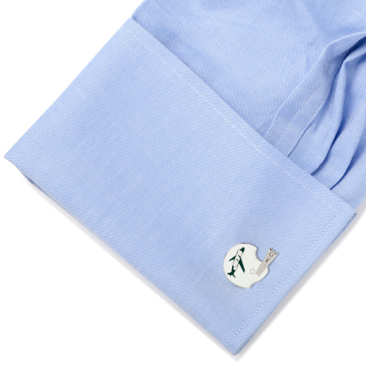 A shirt cuff wearing silver-toned NFL New York Jets Retro Helmet Cufflinks featuring a green airplane logo.