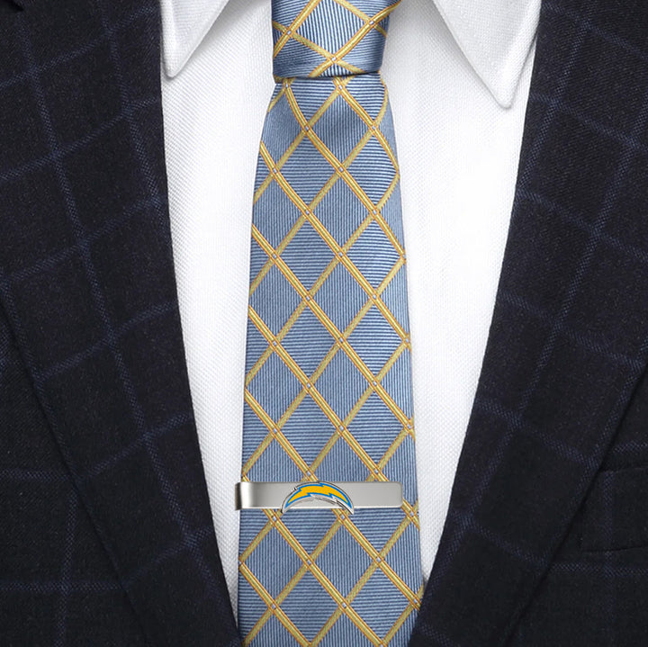 Silver-tone NFL Los Angeles Chargers Tie Bar clipped onto a blue and yellow plaid necktie.