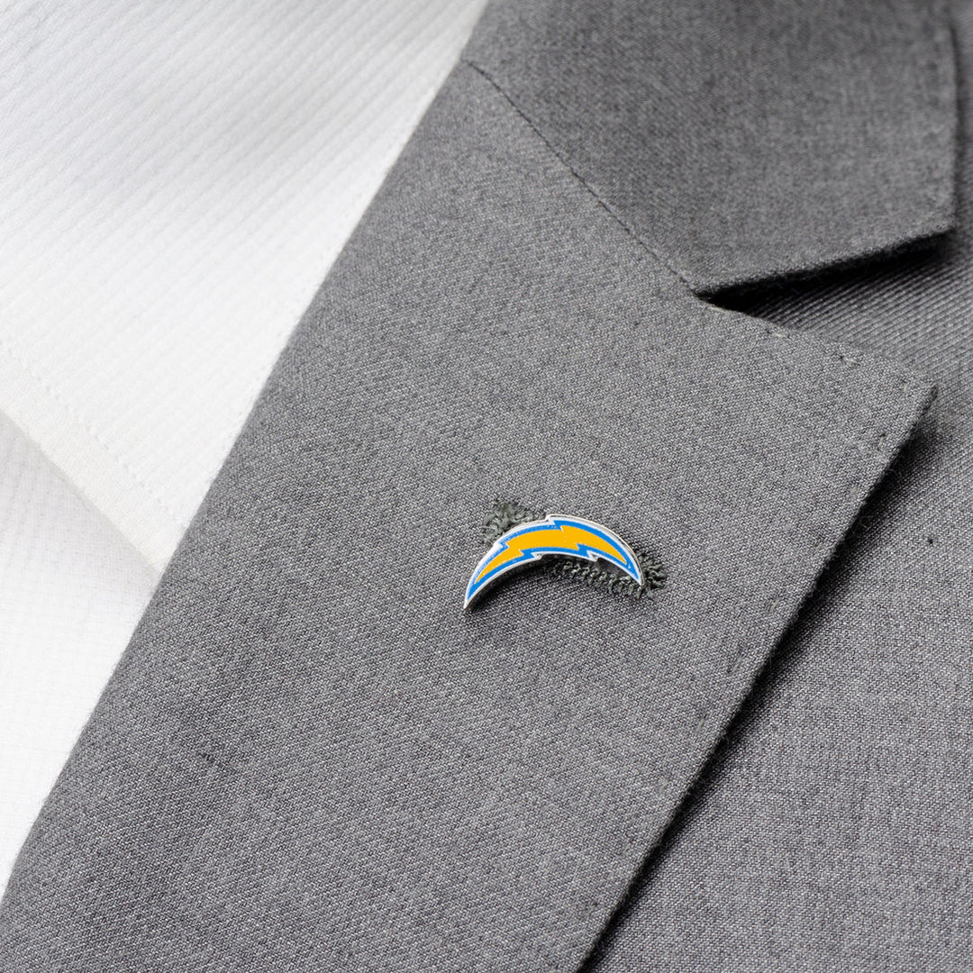 An NFL Los Angeles Chargers Lapel Pin shaped like a lightning bolt logo attached to a grey suit jacket lapel.