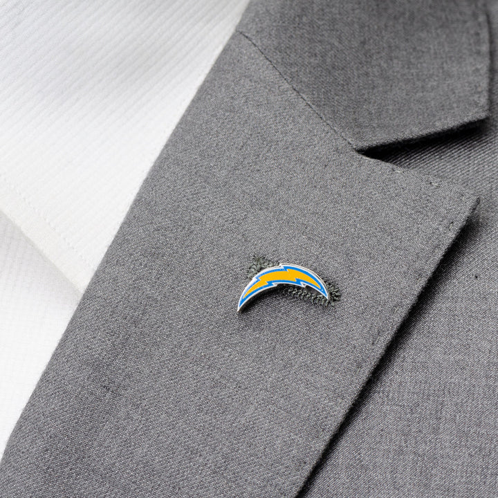 An NFL Los Angeles Chargers Lapel Pin shaped like a lightning bolt logo attached to a grey suit jacket lapel.