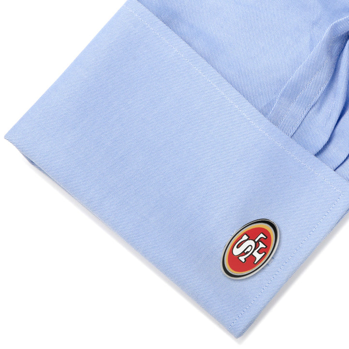 Oval NFL San Francisco 49ers Cufflinks attached to a light blue dress shirt cuff.