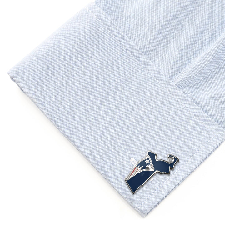 NFL New England Patriots State Shaped Cufflinks in the shape of Massachusetts on a light blue shirt cuff.