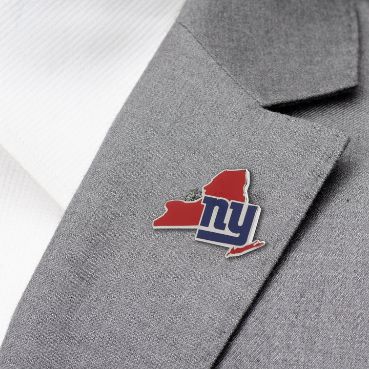 NFL New York Giants State Shaped Lapel Pin in the shape of the team’s red, white, and blue logo on a grey suit jacket.