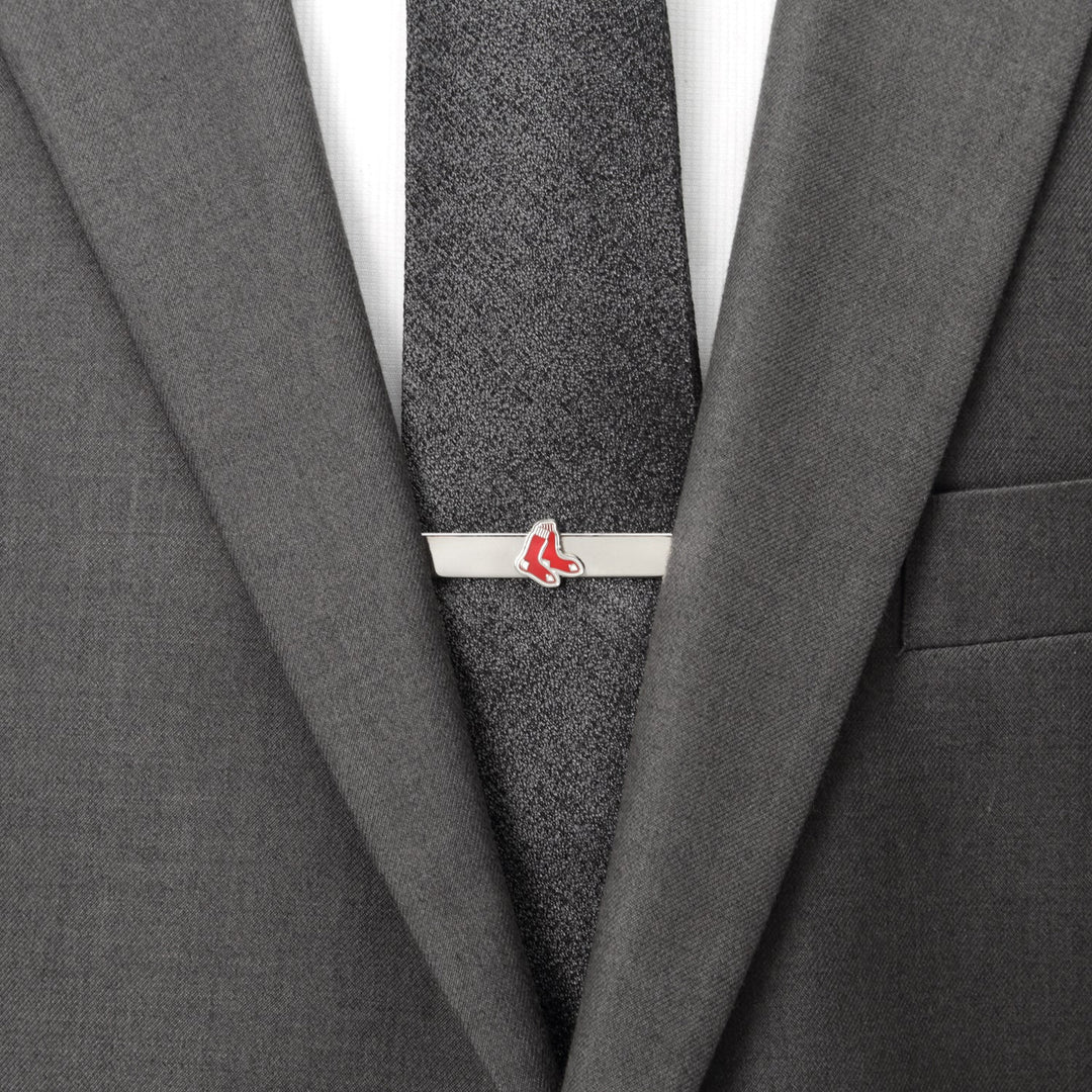 A silver Boston Red Sox tie bar from the MLB Boston Red Sox Cufflinks and Tie Bar Gift Set, featuring the red sock logo on a dark gray tie and suit jacket.