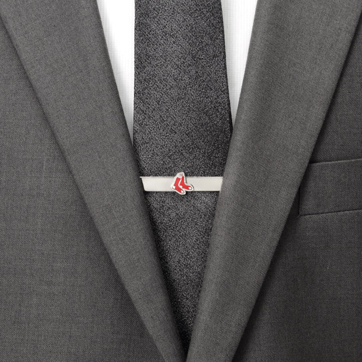 A silver Boston Red Sox tie bar from the MLB Boston Red Sox Cufflinks and Tie Bar Gift Set, featuring the red sock logo on a dark gray tie and suit jacket.