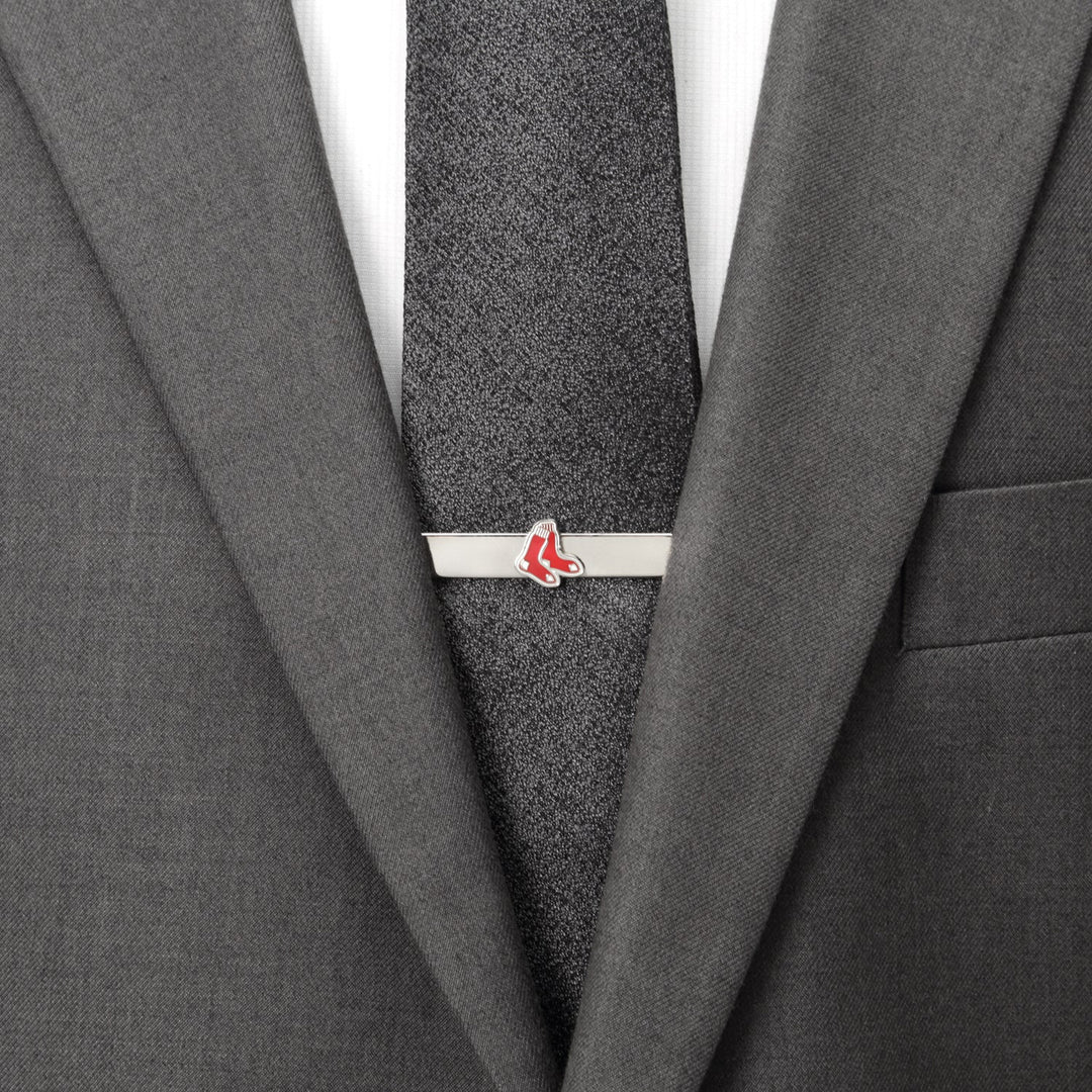 An MLB Boston Red Sox Tie Bar featuring a red sock logo, clipped onto a dark grey textured necktie and suit jacket.