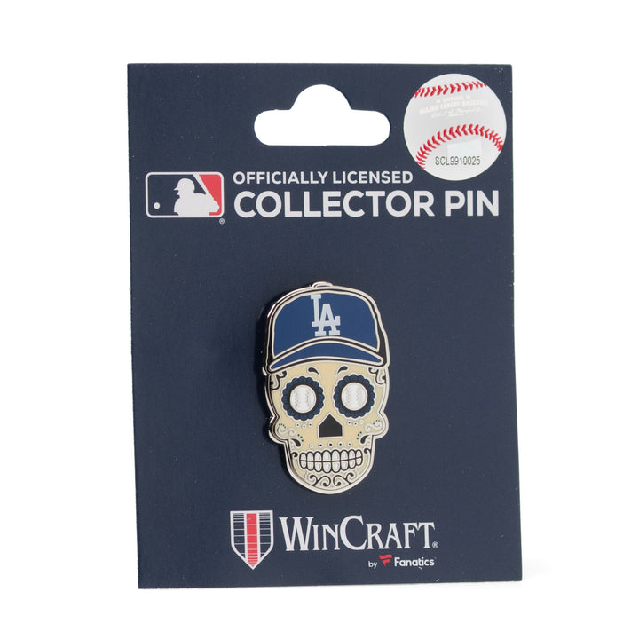 An MLB LA Dodgers Sugar Skull Lapel Pin shaped like a metal sugar skull wearing a blue and white baseball cap, mounted on a display card.