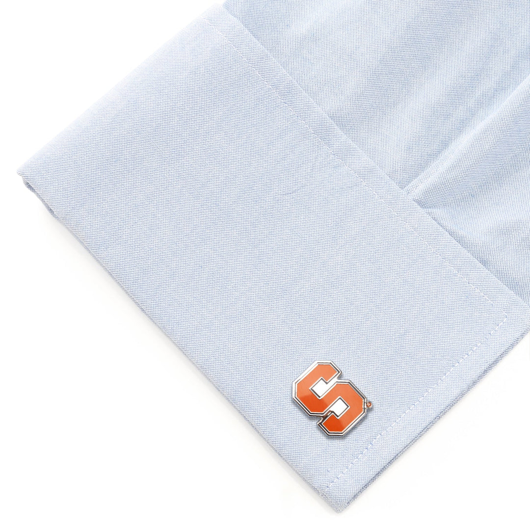NCAA Syracuse University Cufflinks featuring an orange and silver block letter S logo on a light blue dress shirt cuff.