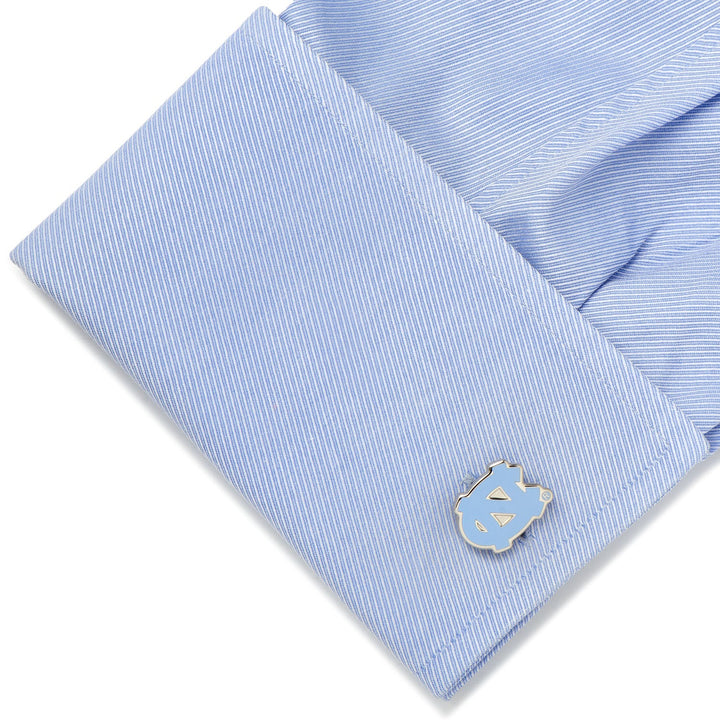 Light blue button-down shirt cuff featuring a silver and light blue NCAA University of North Carolina Tar Heels Cufflinks.
