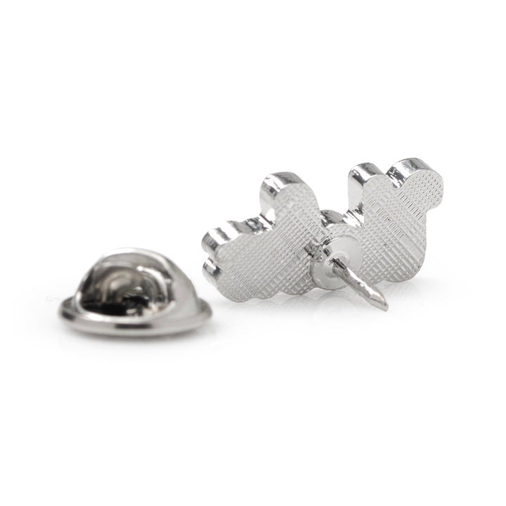 Back view of a silver-toned NCAA UCLA Bruins Lapel Pin showing the textured metal surface and post, with a separate pin clutch lying nearby.