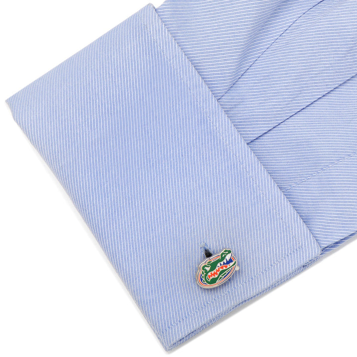 A blue dress shirt cuff fastened with an enamel alligator-shaped NCAA University of Florida Gators Cufflinks.