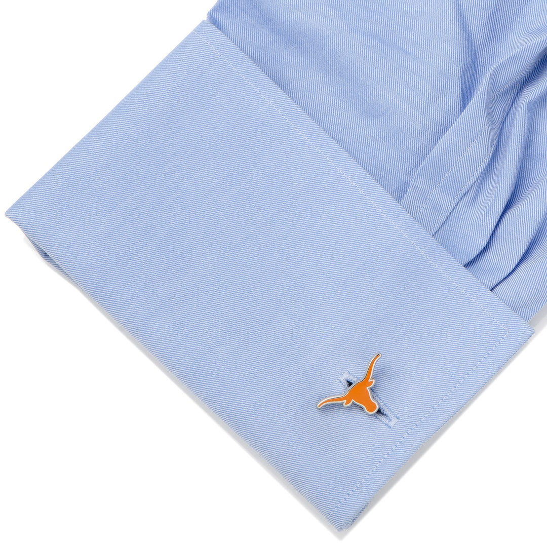 Light blue dress shirt cuff fastened with an orange NCAA Texas Longhorns Cufflinks.