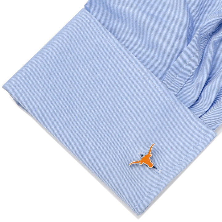 Light blue dress shirt cuff fastened with an orange NCAA Texas Longhorns Cufflinks.