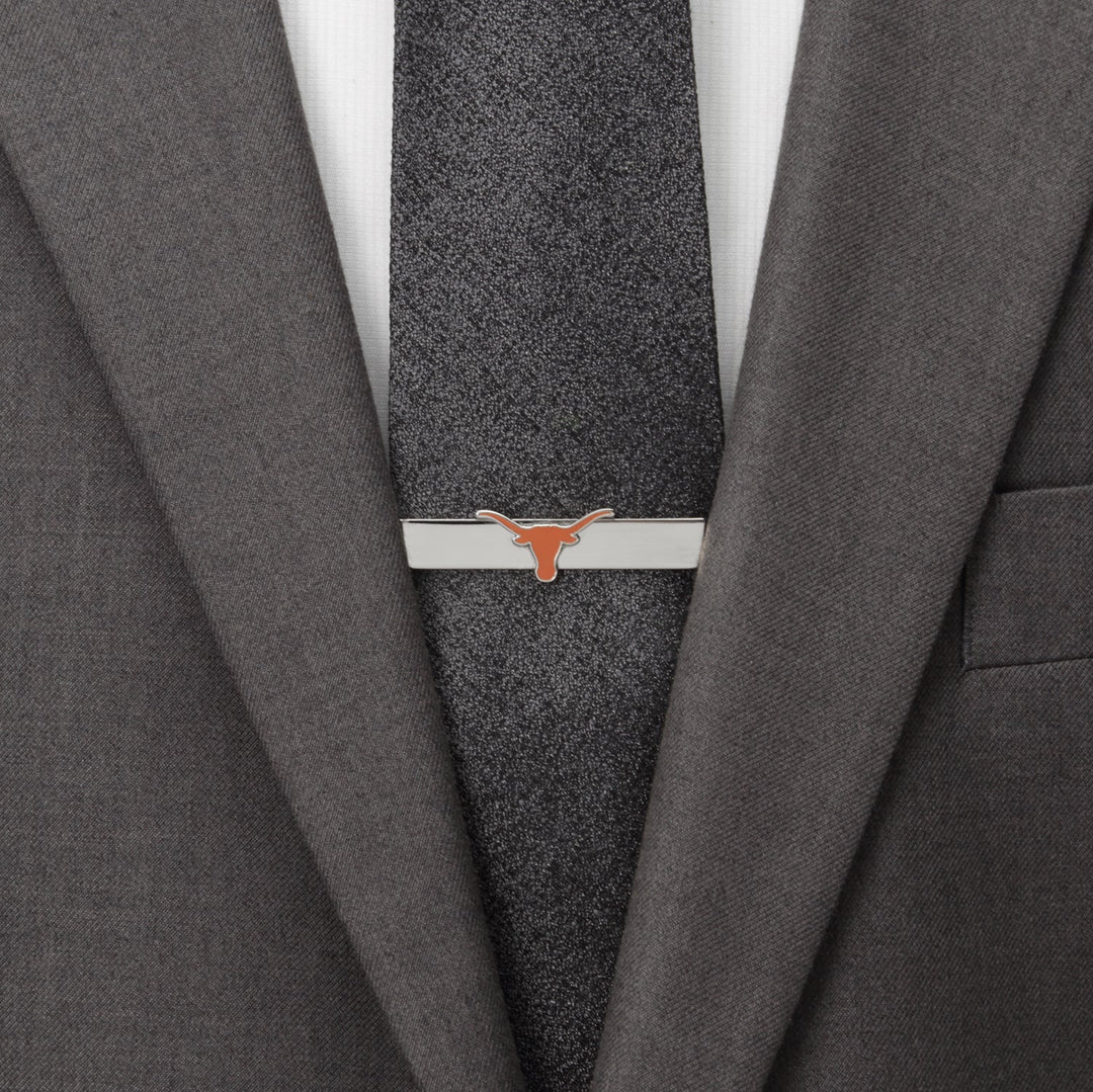 NCAA University of Texas Longhorns Tie Bar featuring an orange longhorn steer logo, clipped to a dark gray tie and suit jacket.