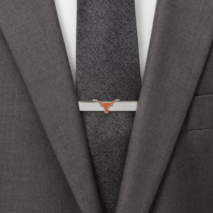 NCAA University of Texas Longhorns Tie Bar featuring an orange longhorn steer logo, clipped to a dark gray tie and suit jacket.