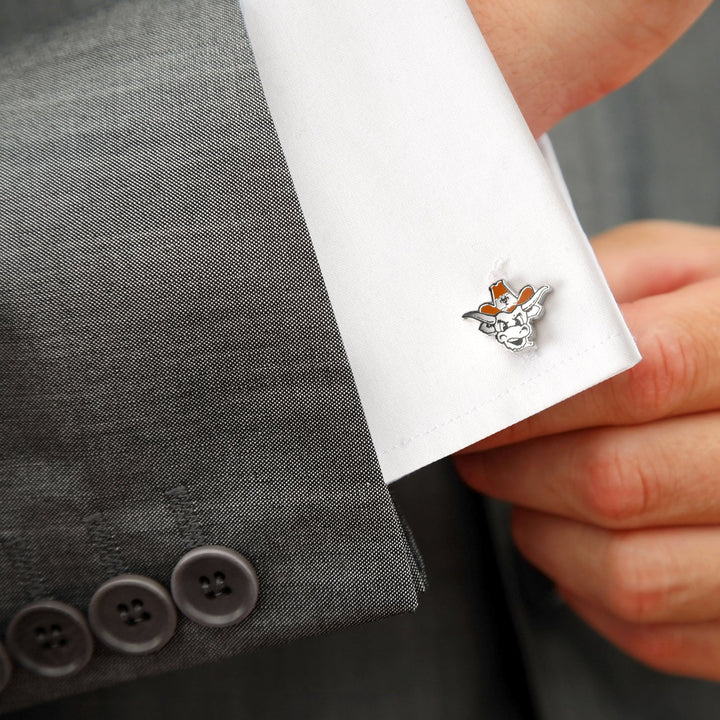 Silver-toned NCAA University of Texas Bevo Cufflinks featuring a longhorn steer head with orange accents, fastened to a white dress shirt sleeve.