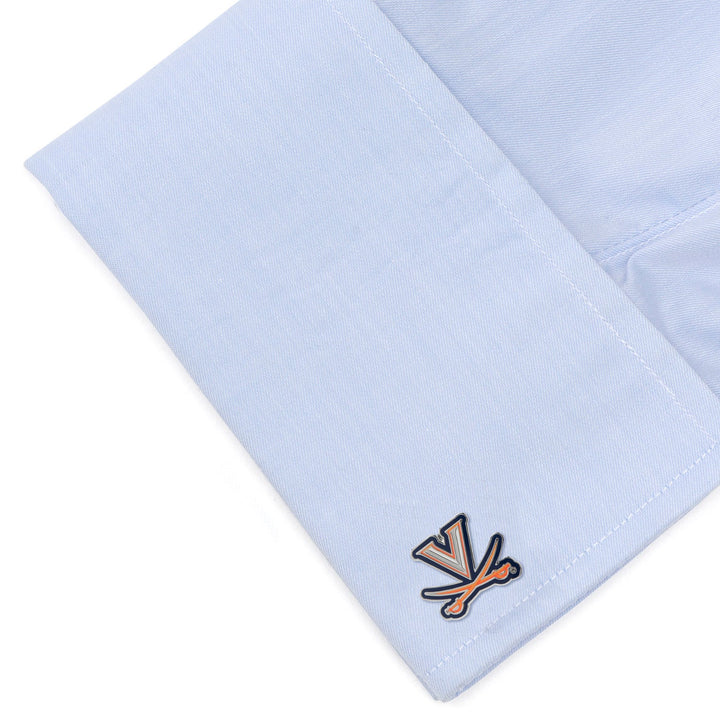 A light blue shirt cuff featuring a pair of orange and blue NCAA University of Virginia Cavaliers Cufflinks.