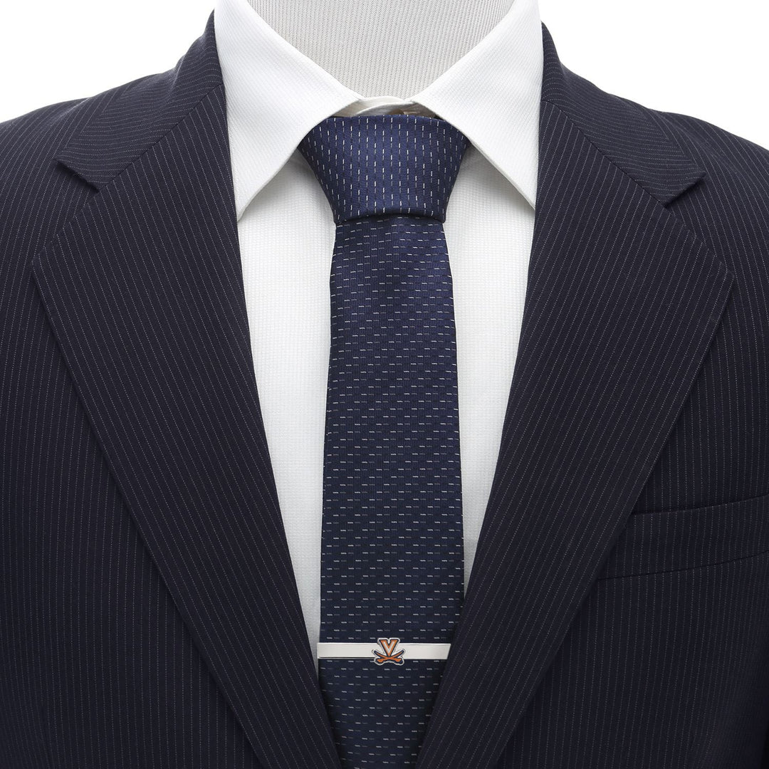 A silver NCAA University of Virginia Cavaliers Tie Clip worn on a blue patterned necktie.