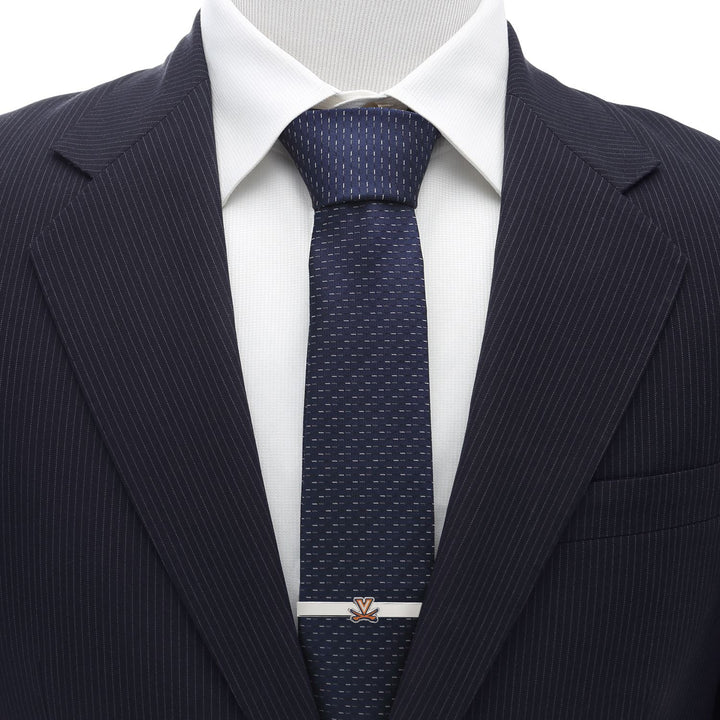 A silver NCAA University of Virginia Cavaliers Tie Clip worn on a blue patterned necktie.