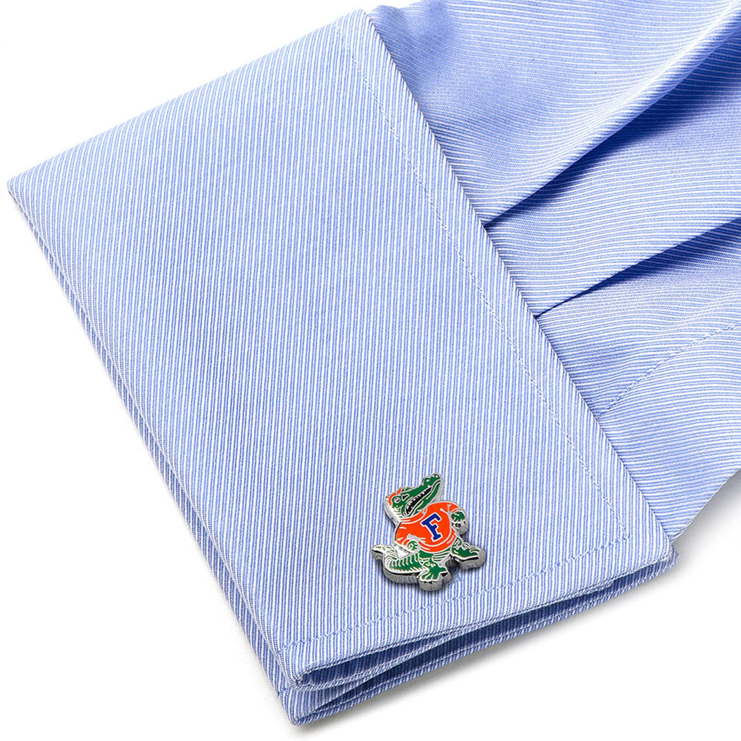 NCAA University of Florida Throwback Cufflinks featuring a cartoon alligator in an orange shirt with a blue letter F, attached to a light blue dress shirt cuff.