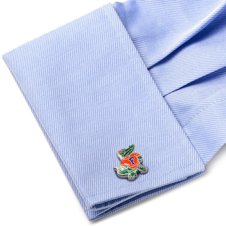 NCAA University of Florida Throwback Cufflinks featuring a cartoon alligator in an orange shirt with a blue letter F, attached to a light blue dress shirt cuff.
