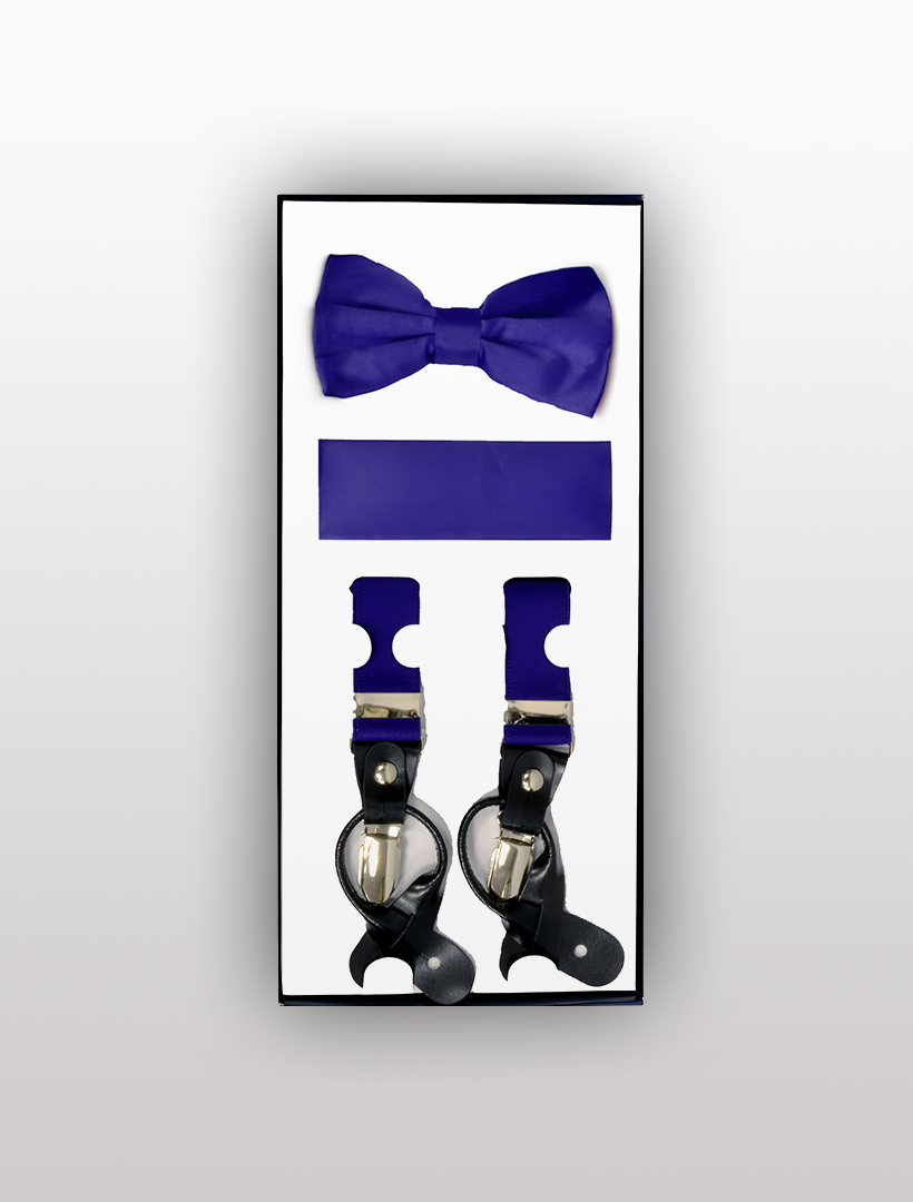 The Men's Skinny Purple 3 Piece Suspenders Set by Vesuvio Napoli includes a boxed set featuring a purple bow tie, a purple cummerbund, and a pair of adjustable purple suspenders with black leather details and silver clasps.