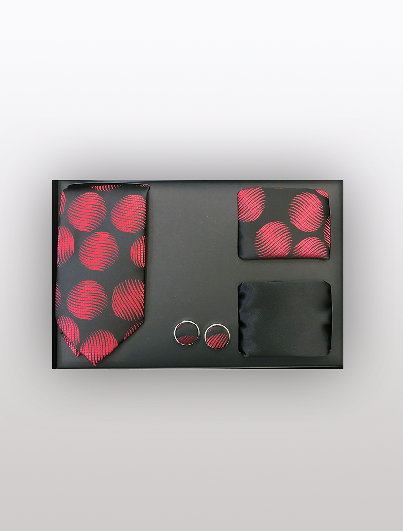 The Men's Four Piece Red and Black Wavy Circle Gift Box by Vesuvio Napoli is an elegant choice for formal events, featuring a slim fit tie, pocket squares, and cufflinks. The tie and one pocket square showcase a striking red circle pattern, complemented by another solid black square. The cufflinks flawlessly align with the tie's design.