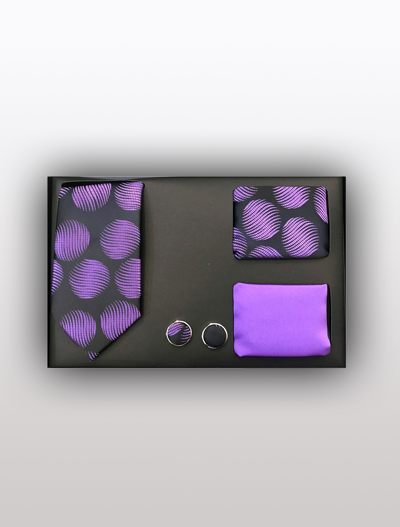 The Men's Four Piece Purple and Black Wavy Circle Gift Box by Vesuvio Napoli offers a sophisticated ensemble, featuring a slim fit purple and black wavy circle tie, a coordinating pocket square, a solid purple handkerchief, and circular cufflinks—ideal for formal occasions.