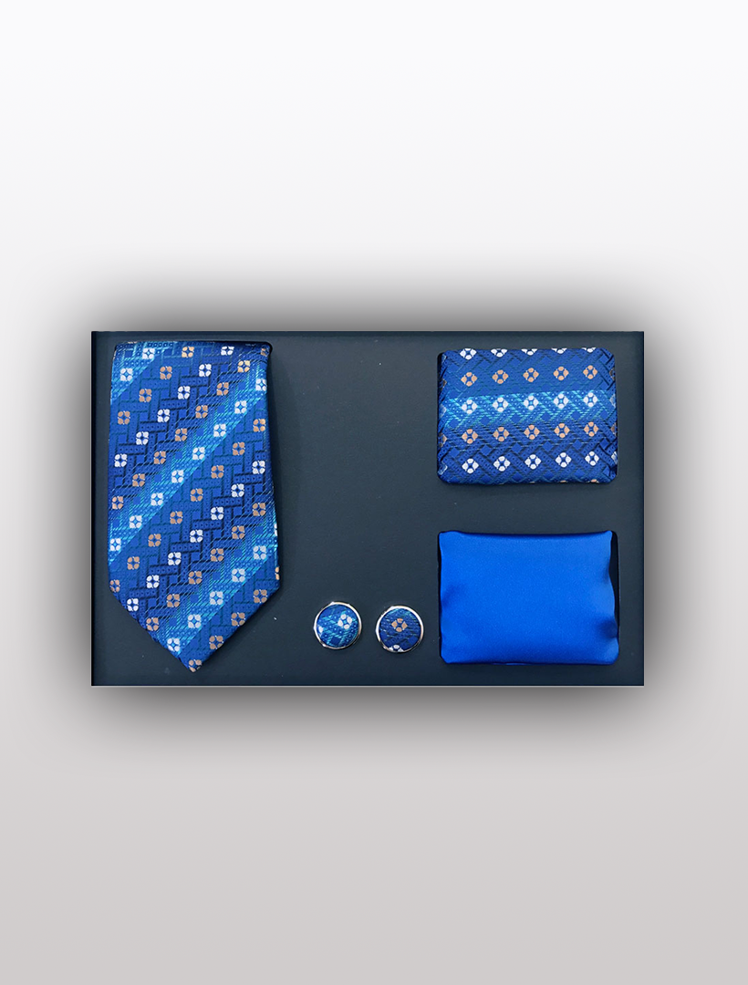 The Vesuvio Napoli Men's Four Piece Blue Square Patterned Gift Box includes a patterned slim fit tie, matching pocket square, cufflinks, and a plain handkerchief, making it perfect for formal events.