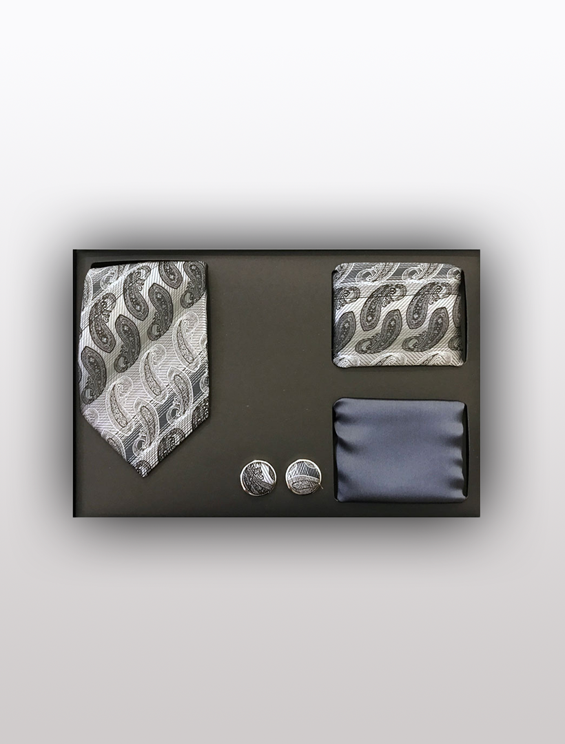 The Men's Four Piece Grey Paisley Stripe Patterned Gift Box by Vesuvio Napoli includes a slim fit paisley tie, a matching pocket square, a black pocket square, and coordinating cufflinks, all elegantly arranged in a sleek black box.