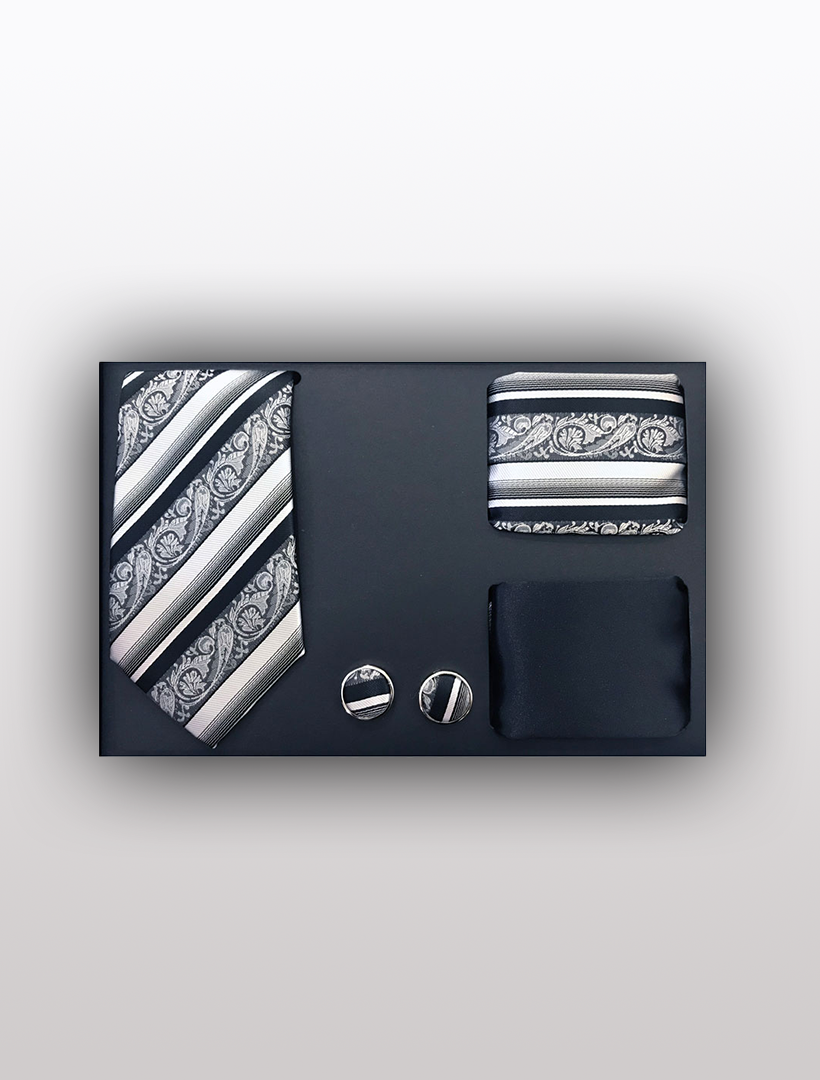 Introducing the Vesuvio Napoli Men's Four Piece Black Paisley Stripe Patterned Gift Box, featuring a striped tie, pocket square, cufflinks, and matchbox in black and silver—perfect for achieving a polished look at formal events.