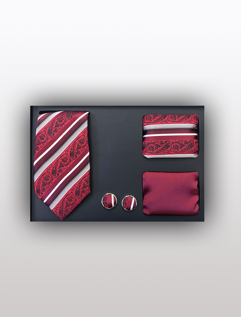 The Men's Four Piece Red and White Paisley Stripe Patterned Gift Box by Vesuvio Napoli offers a chic presentation, featuring a slim fit tie with red patterns, a coordinating pocket square, stylish cufflinks, and a solid red pocket square, all elegantly arranged against a sophisticated black backdrop—ideal for formal occasions.