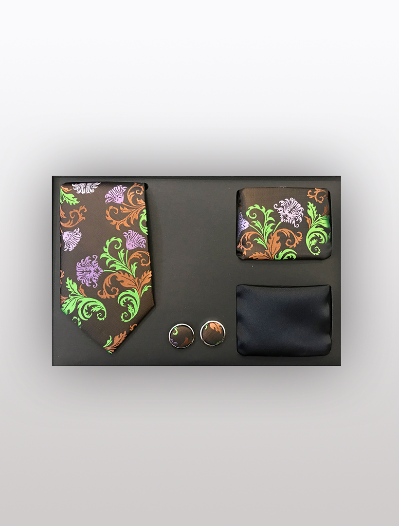 The Vesuvio Napoli Men's Four Piece Brown and Green Floral Patterned Gift Box offers a sophisticated slim fit tie set. This stylish ensemble features a floral design in green, purple, and orange, including a tie, pocket square, cufflinks, and an elegant black fabric piece. All items are beautifully presented in a black gift box. Crafted from high-quality polyester for both durability and style.