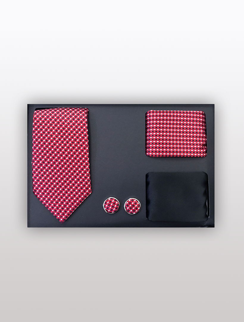 The Vesuvio Napoli Men's Four Piece Red and White Small Checkered Patterned Gift Box is an ideal choice for formal events, featuring a slim fit tie with red and white patterns, a coordinating pocket square, two cufflinks, and an additional solid black pocket square—all beautifully presented in a gift box on a sleek black display.