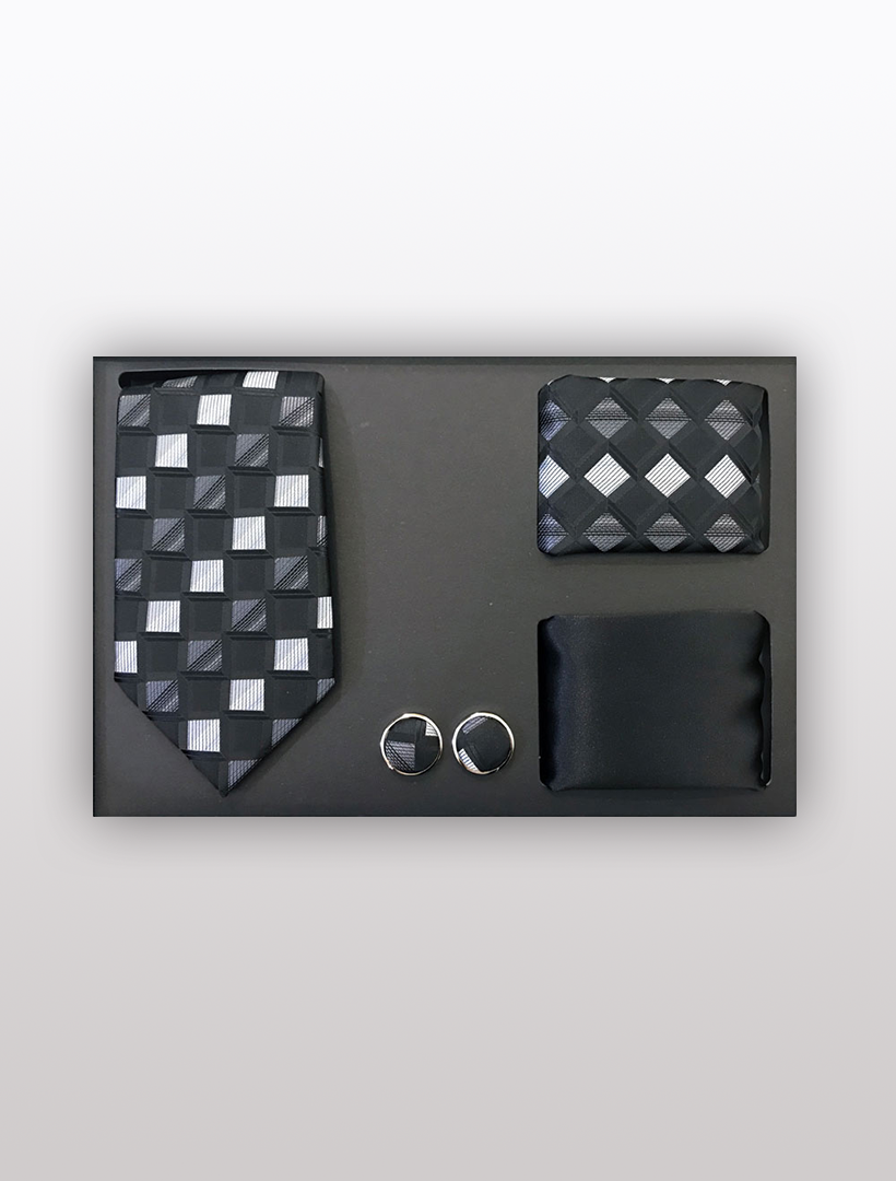 The Men's Four Piece Black and White Checkered Patterned Gift Box by Vesuvio Napoli includes a slim fit tie, pocket square, cufflinks, and tie clip in a stylish black and silver checkered design—perfect for adding elegance to formal events.