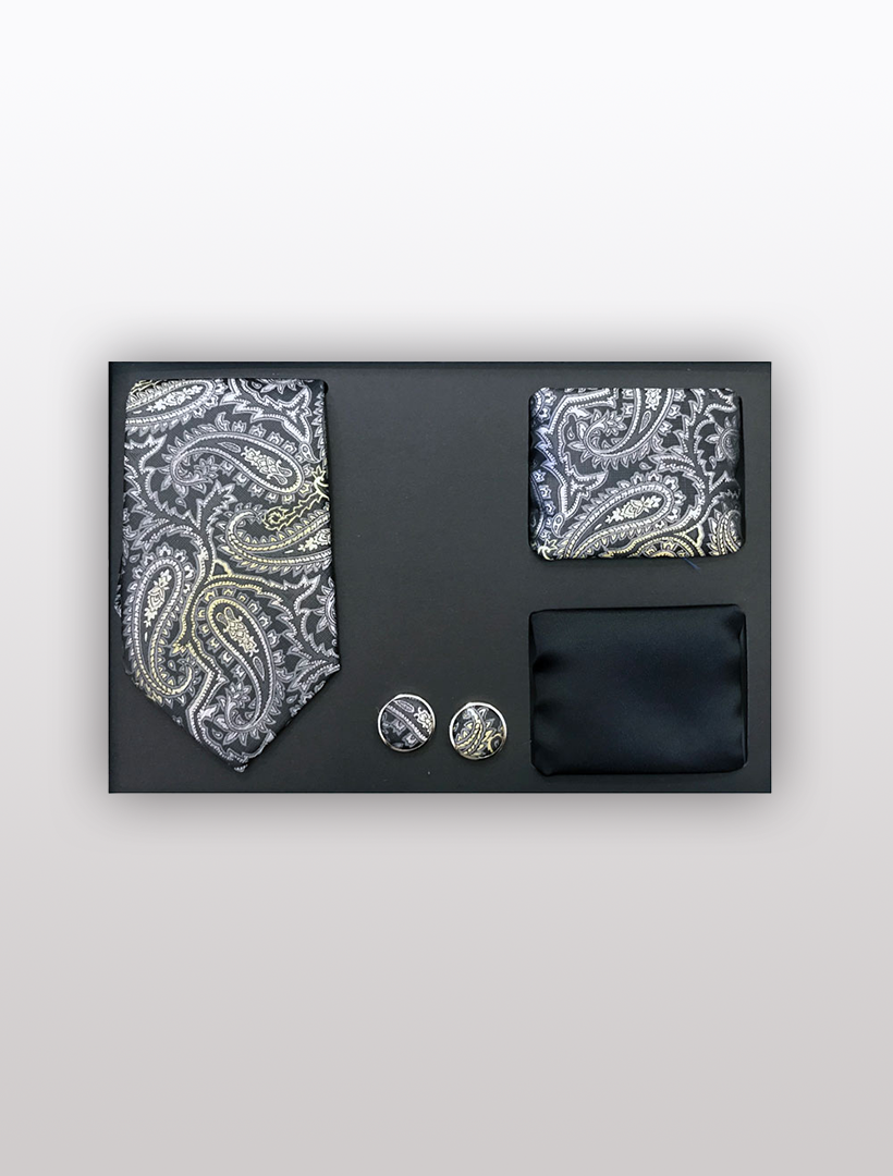 The Men's Four Piece Black and Grey Paisley Patterned Gift Box by Vesuvio Napoli includes a slim fit paisley tie, a matching pocket square, and two round cufflinks, all elegantly arranged on a black surface. Ideal for formal events or adding a touch of class to any outfit, this stylish set comes in an elegant gift box for a sophisticated presentation.